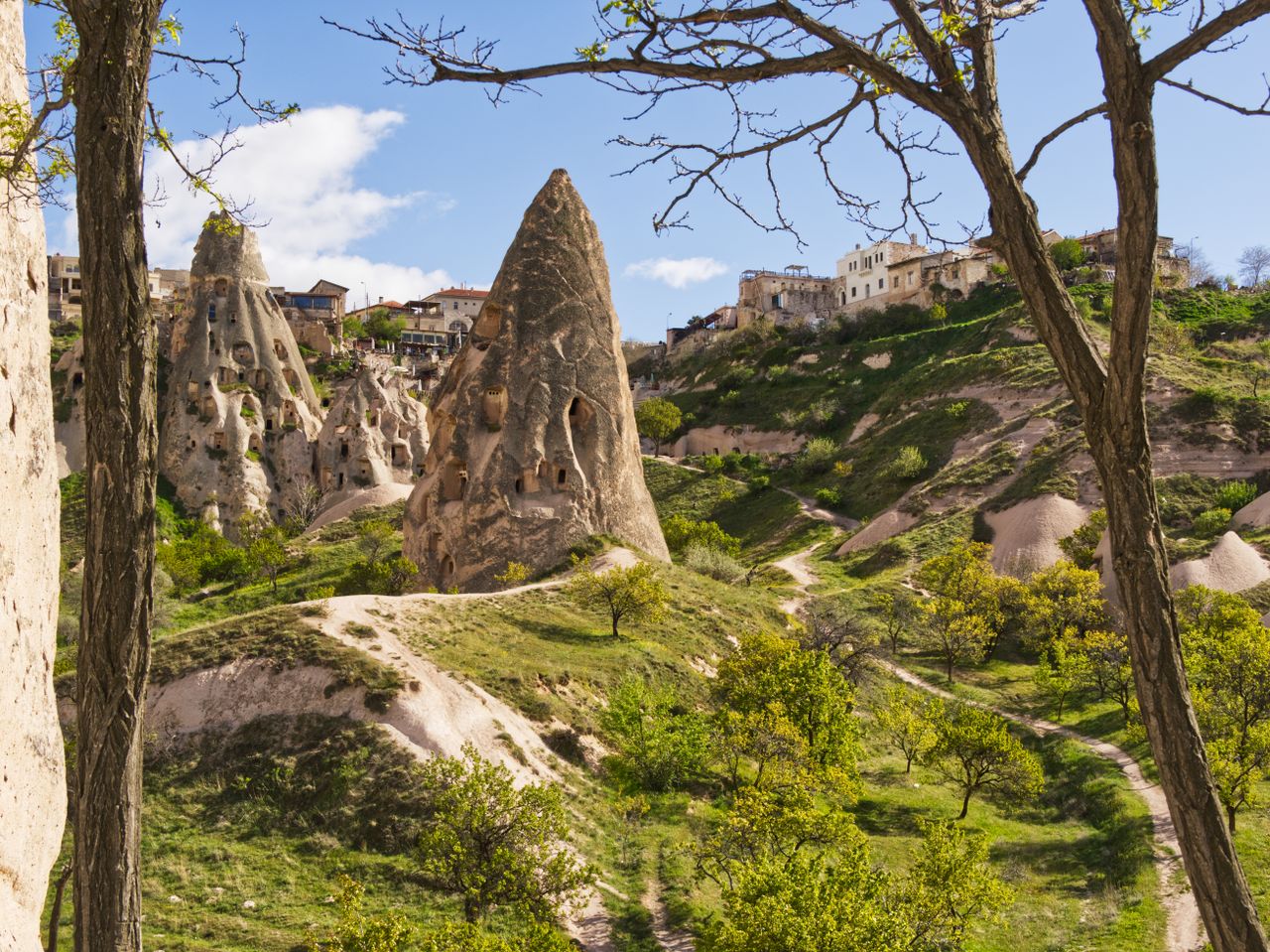 Explore the unique rock formations and ancient dwellings in Cappadocia, Türkiye.